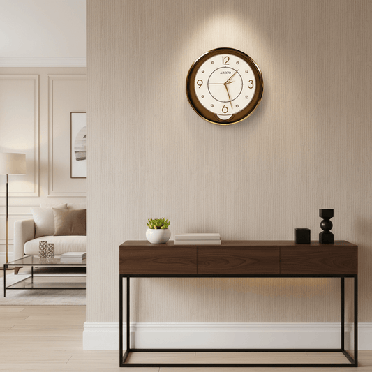 Aristo wall clock with gold casing and white face on a light gray background