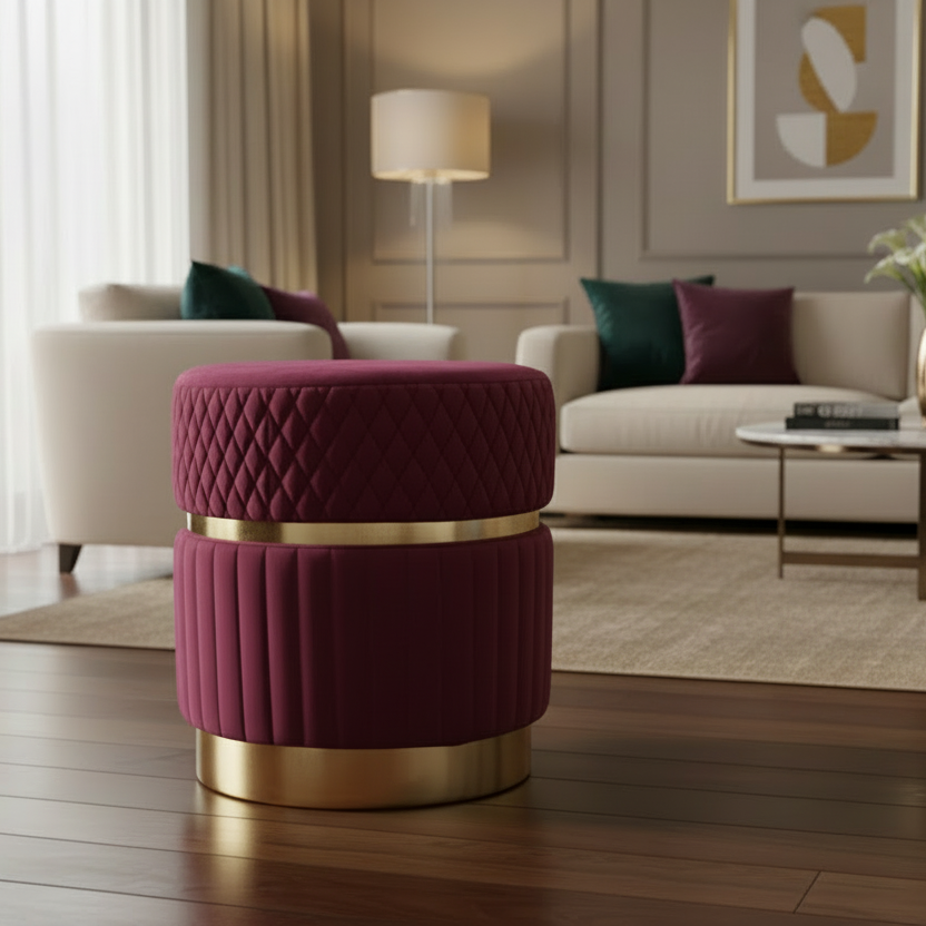 Maroon ottoman with gold base in a living room setting