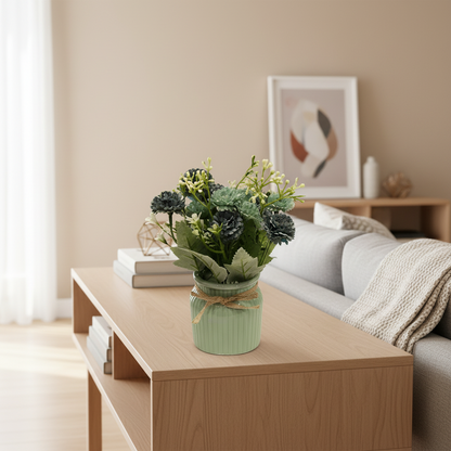 Artificial flower arrangement in a green vase with a twine bow on a light background