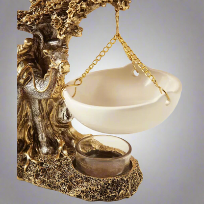 Decorative sculpture of a dragon with a bowl and cup on a gray background