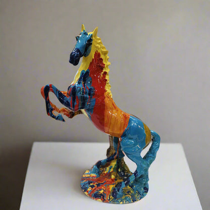 Colorful horse sculpture on a white pedestal against a plain background