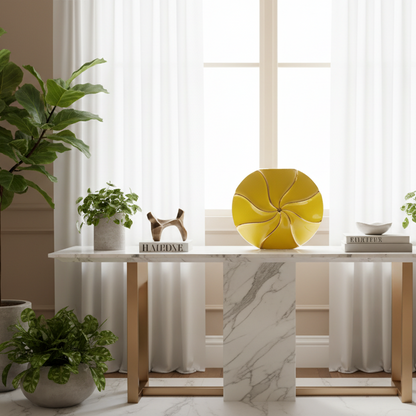 Modern interior with a marble table, yellow decorative item, and plants.