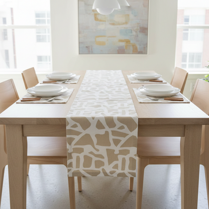Dining table set with a patterned table runner in a bright room.