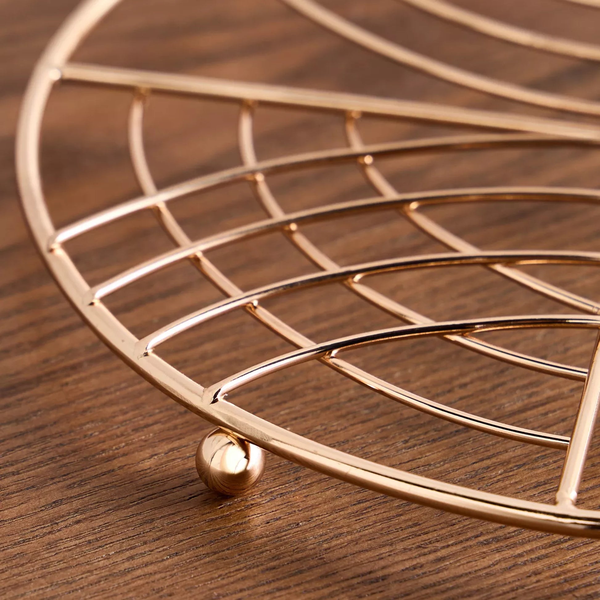 Gold wire basket on a wooden surface