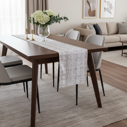 Dining room with a wooden table, chairs, and a vase of flowers.