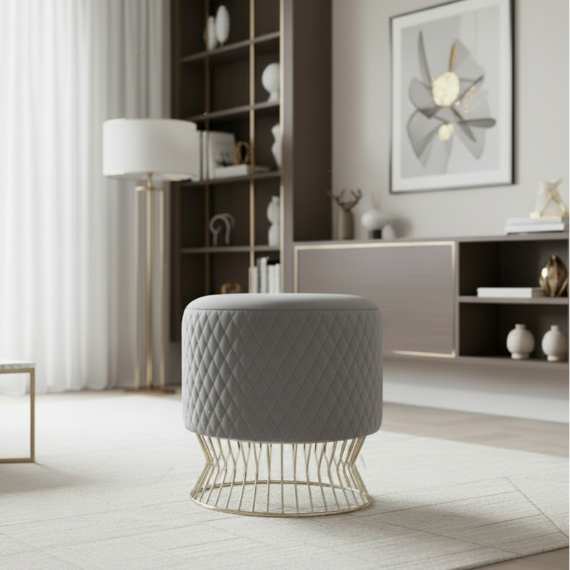 Gray quilted stool with gold base in a modern living room setting