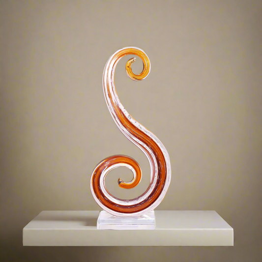Decorative swirl sculpture on a table with a blurred indoor background
