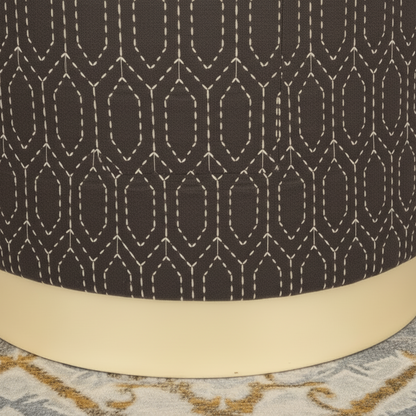 Close-up of a dark brown fabric with a geometric pattern and beige base.