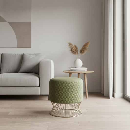 Modern living room with a gray sofa, green ottoman, and decorative items.