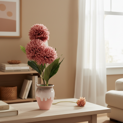 Pink flowers in a vase on a wooden table with a cozy room background
