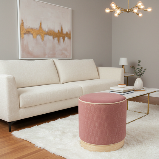 Living room with a beige sofa, pink ottoman, and abstract art on the wall.