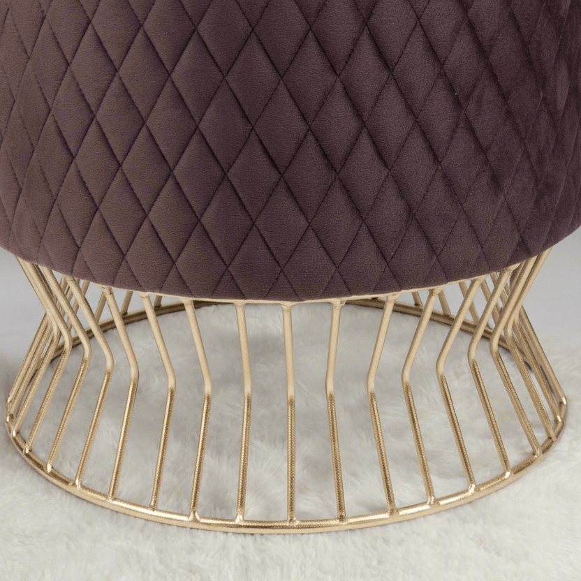 Brown quilted stool with a gold wire base on a light background