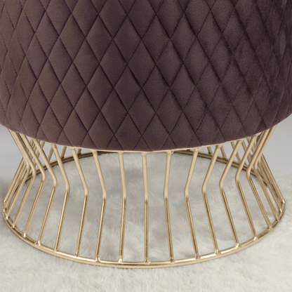 Brown quilted stool with a gold wire base on a light background