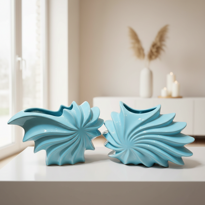 Two turquoise decorative items on a surface with a neutral background