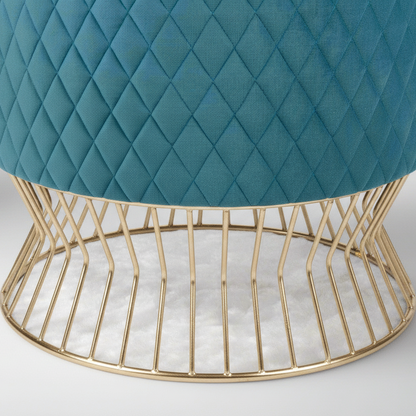 Teal quilted stool with a gold wire base on a light gray background