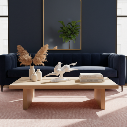 Modern living room with a navy blue sofa, wooden coffee table, and decorative items.