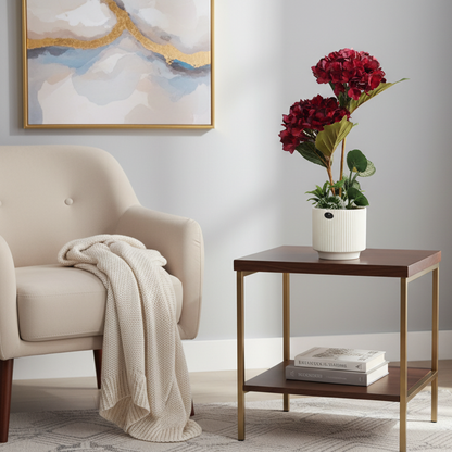 Artificial potted plant with red flowers on a gray background