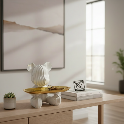 Decorative lamp on a wooden table with books and a plant in a minimalistic room.