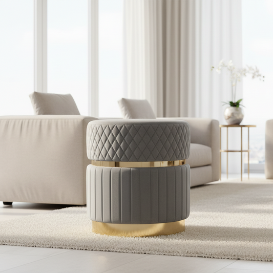 Gray quilted ottoman with gold accents in a modern living room setting