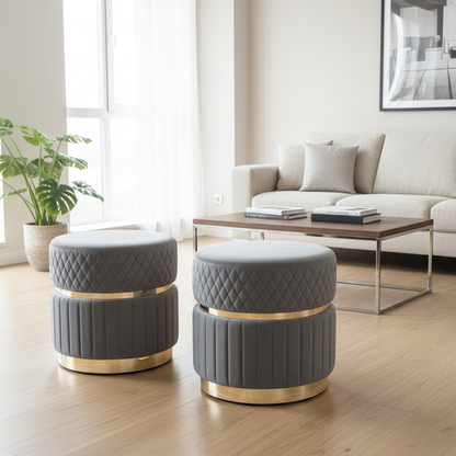 Two gray ottomans with gold bases in a modern living room.