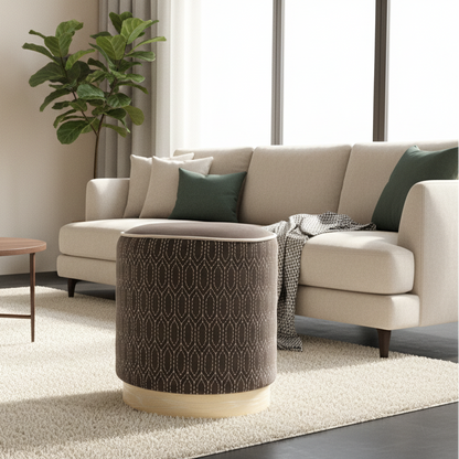 Beige sectional sofa with patterned ottoman in a living room setting