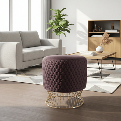 Modern living room with a quilted purple stool, gray sofa, and wooden coffee table.