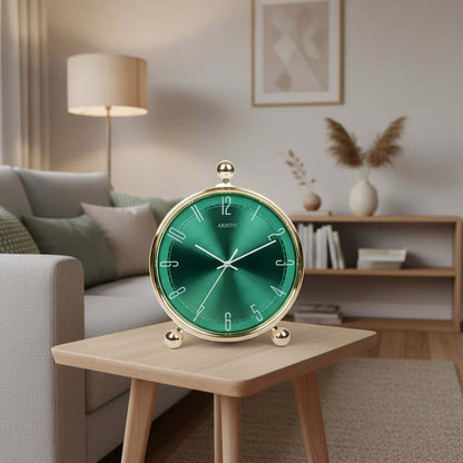 Green clock with gold rim and base on a white background