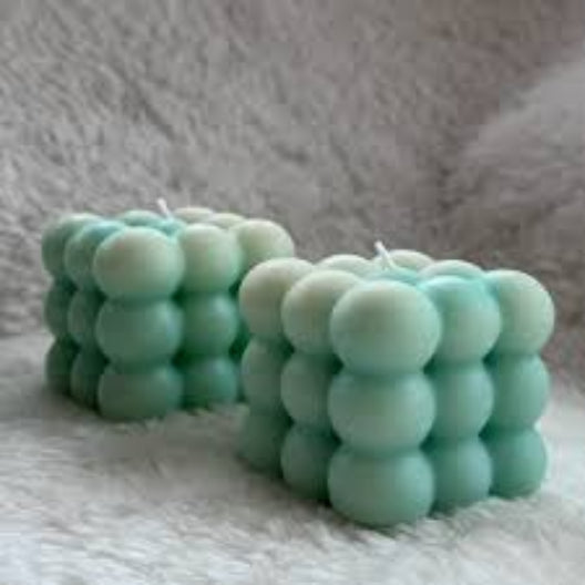 Cube-shaped soy wax candle with green bubbles