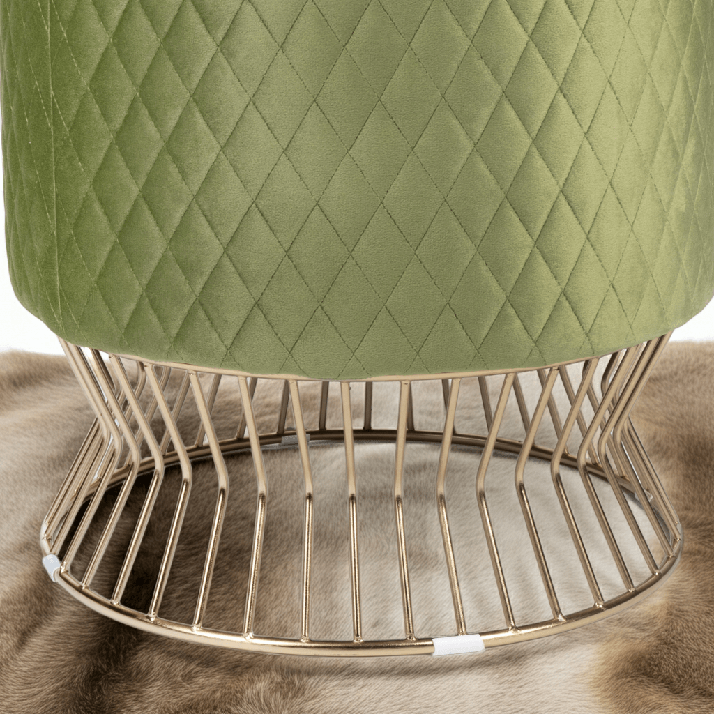 Green quilted stool with a gold wire base on a fur surface