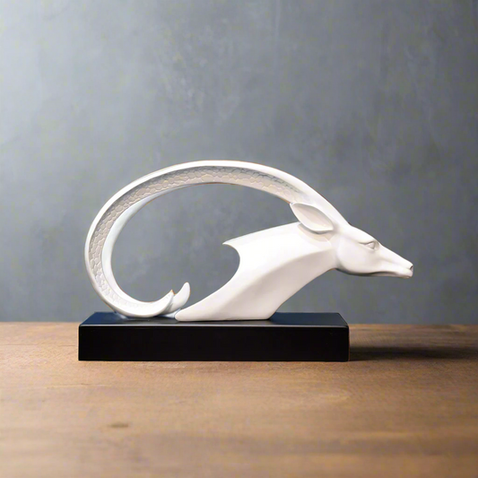 White dragon sculpture on a black base against a wooden paneled wall.