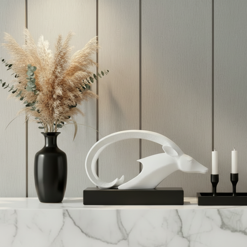 Decorative items on a marble surface with a neutral wall background